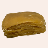 Stack of layered yellowish food item on a gray background