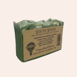 Green soap bar with a brown label on a white background