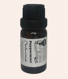 Bottle of peppermint essential oil with a black cap on a light gray background